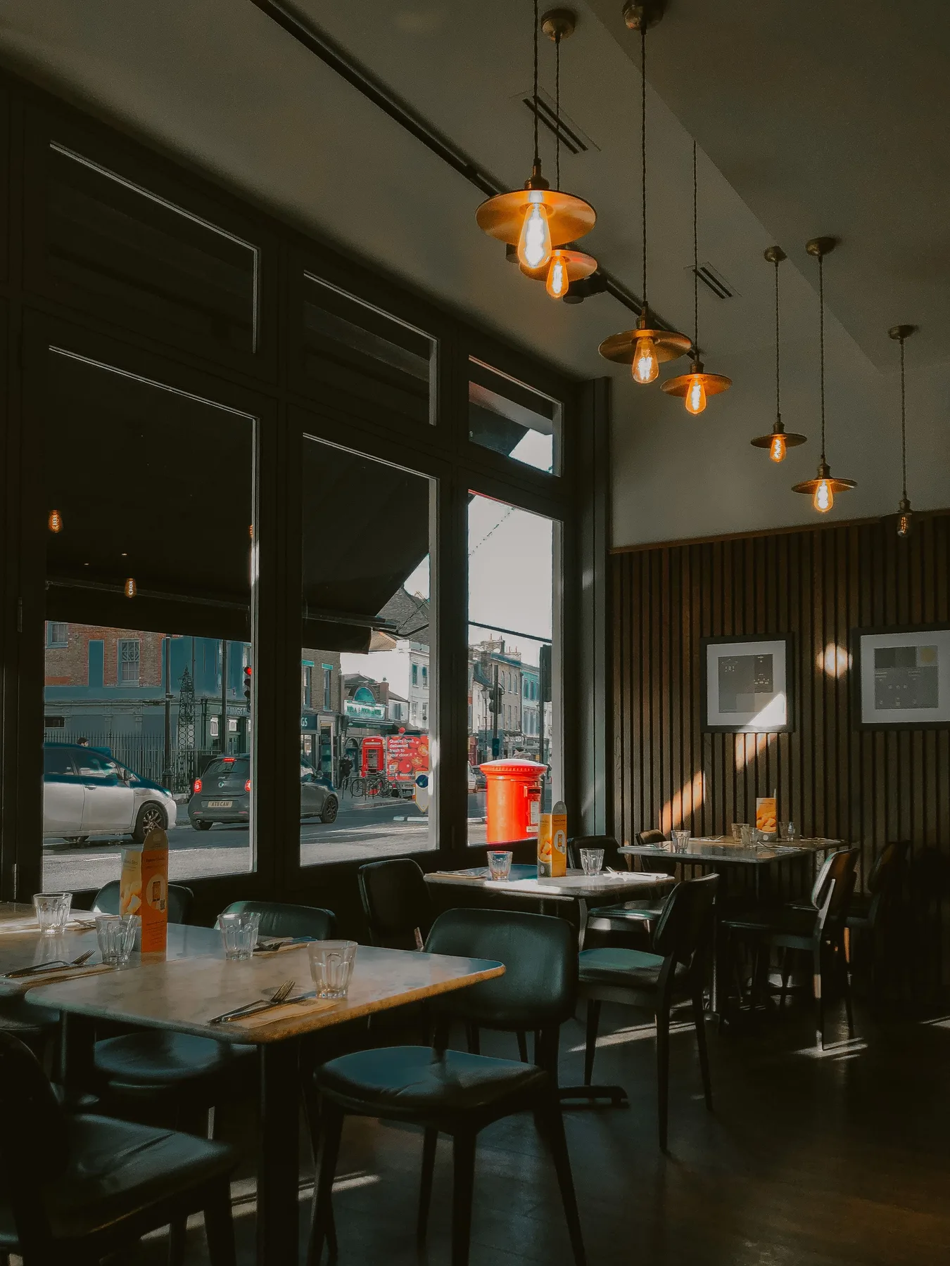 Warmly lit restaurant dining room prepared for guests